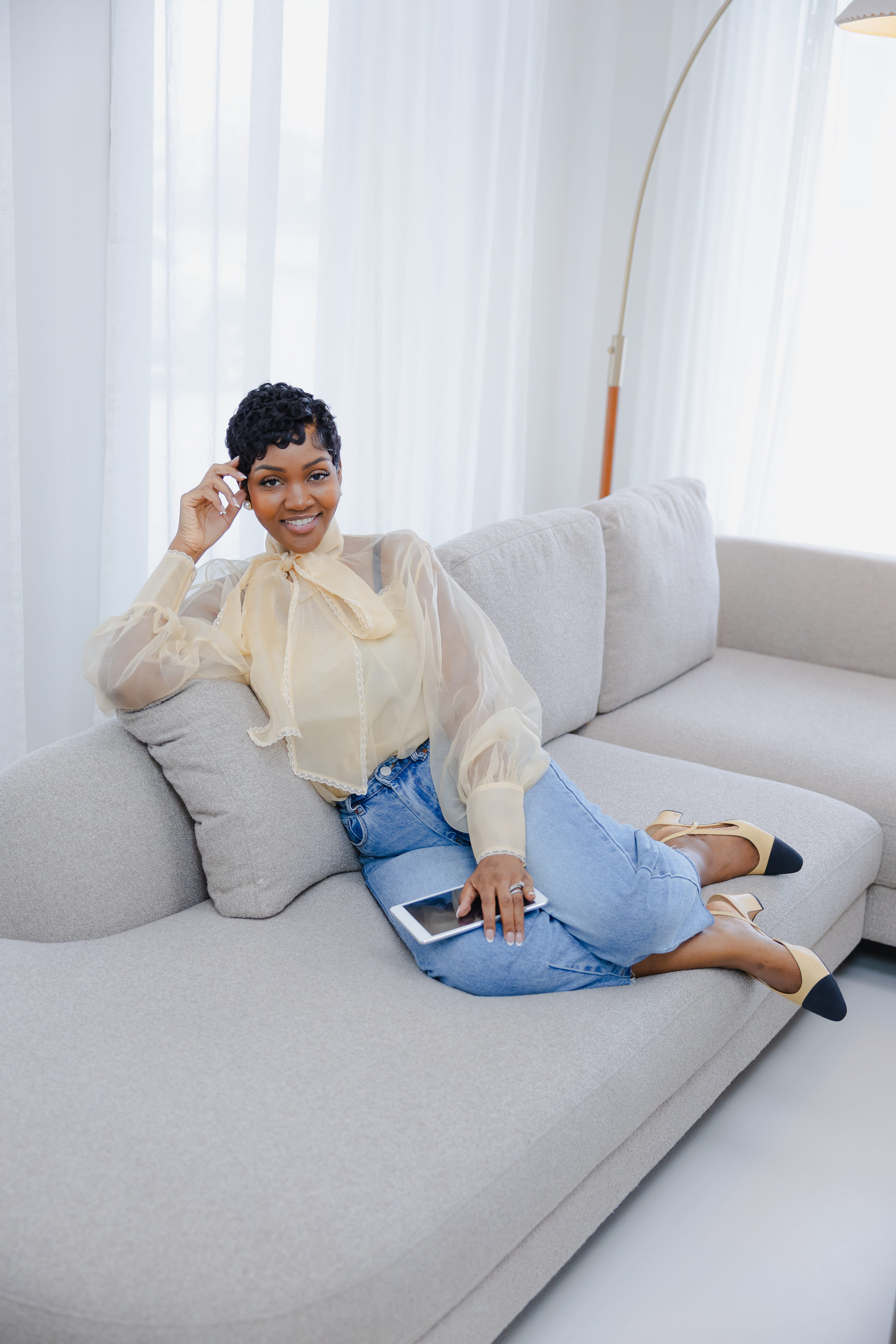 Cleo R. smiling while reviewing a tablet