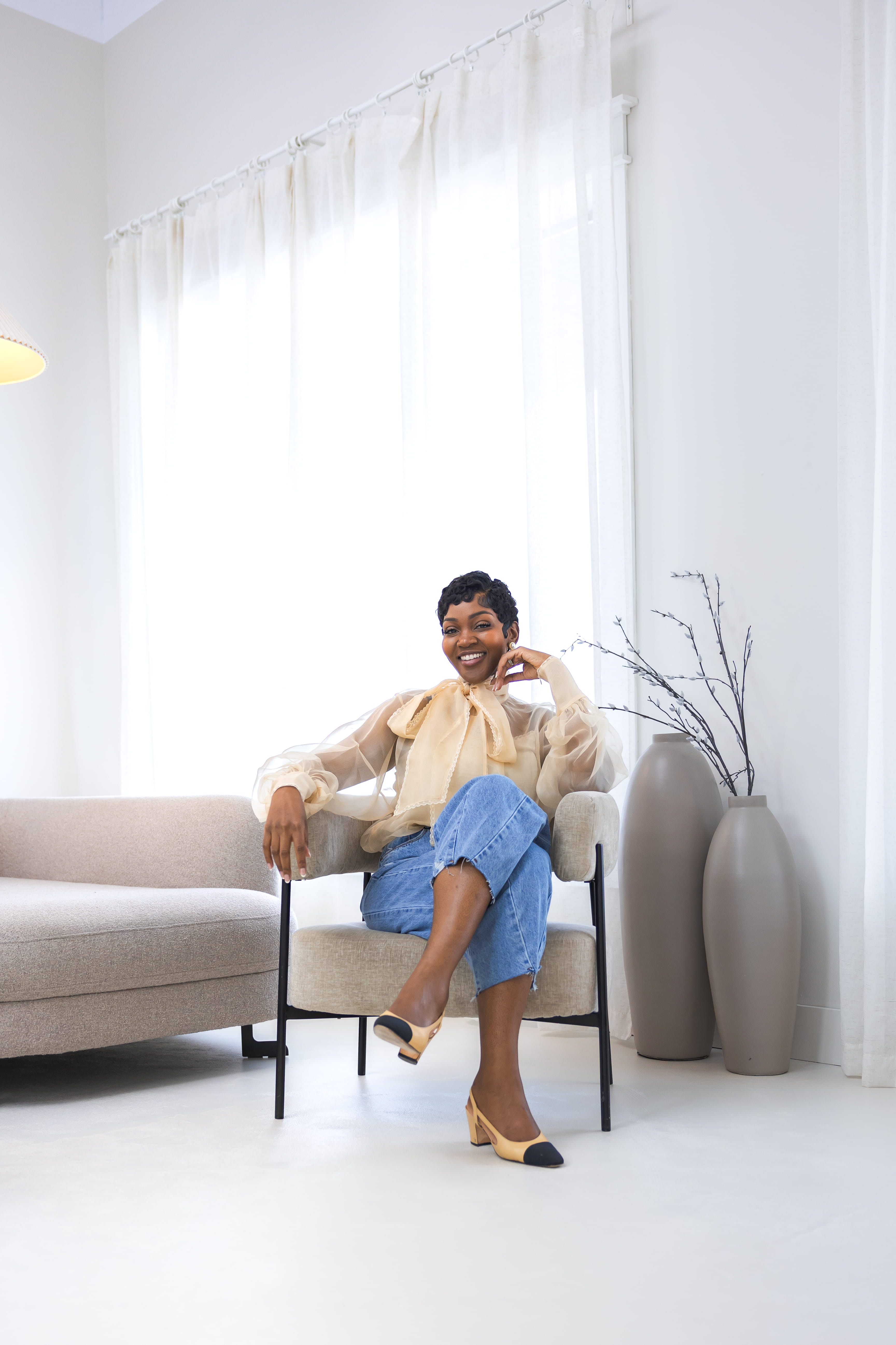Cleo R. seated and smiling warmly