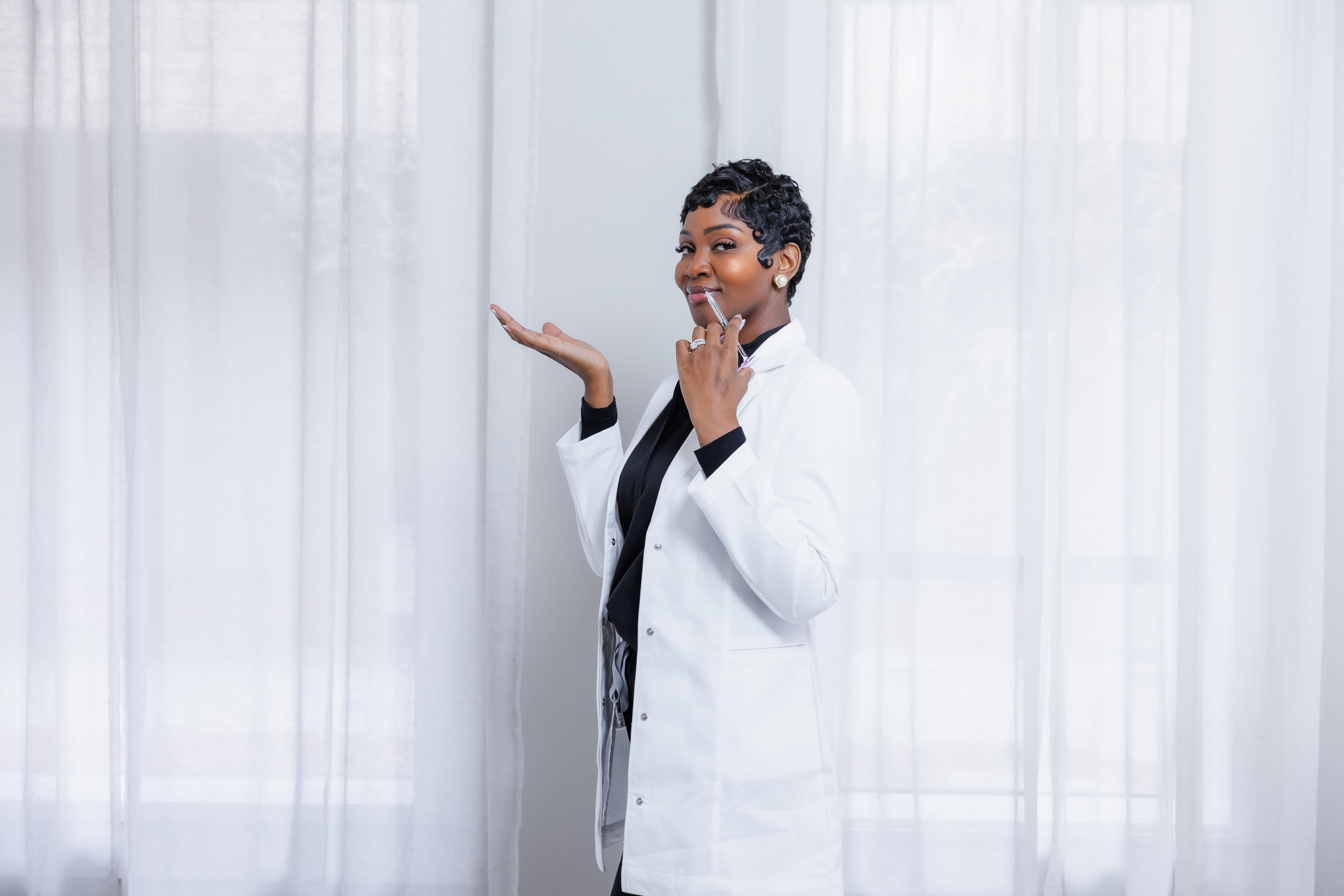 Cleo R. in her white coat holding an aesthetic syringe